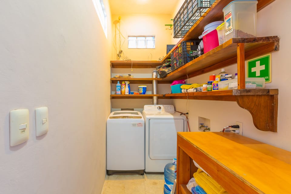 Laundry Room w Large Washer, Dryer & supplies located adjacent to kitchen