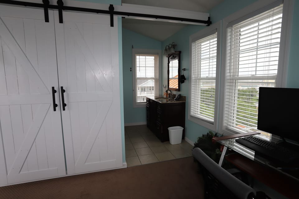 Barn doors slide to close off the bathroom area. 