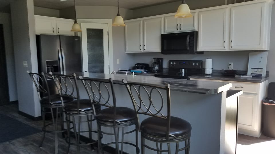 Kitchen with large pantry, bar stools seating