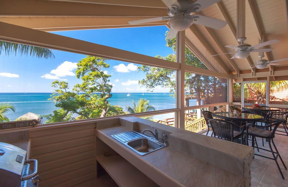 Seating for 8 in screened porch with grill and wet bar