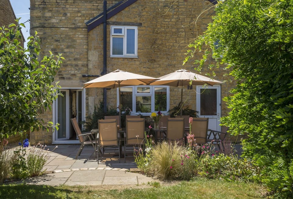 Garden Enclosed garden with table seating twelve guests and barbecue