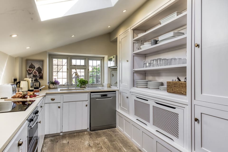 The kitchen with plenty of storage and a cottage garden view