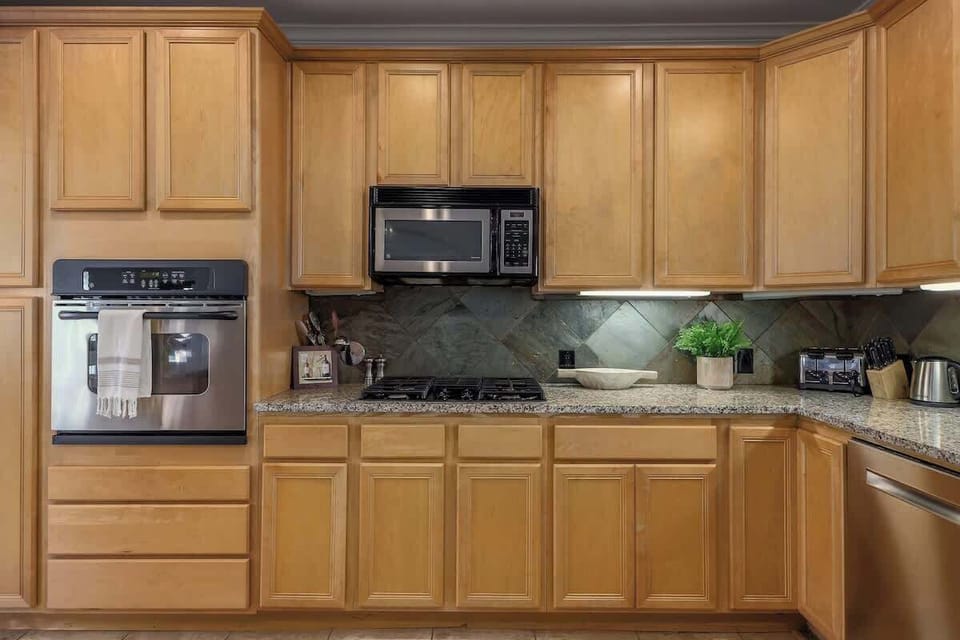 Prepare your favorite meal in the well stocked kitchen which has stainless steel appliances and ample counter space