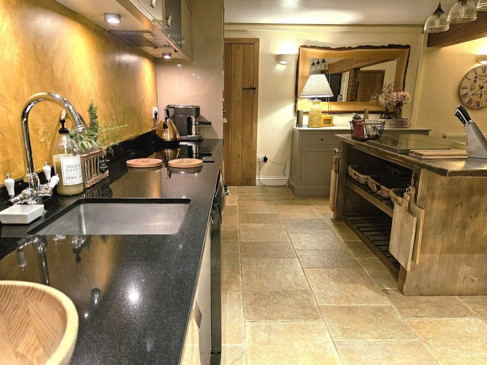 spacious kitchen along one wall with kitchen prep area facing the view