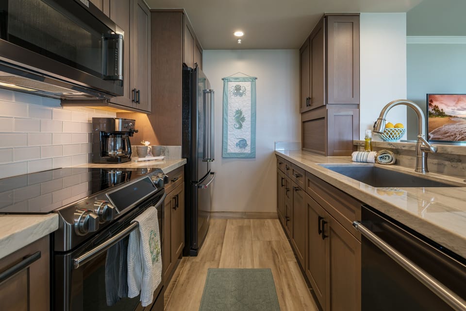 Kitchen Area With All New Cabinetry And Marble Counters