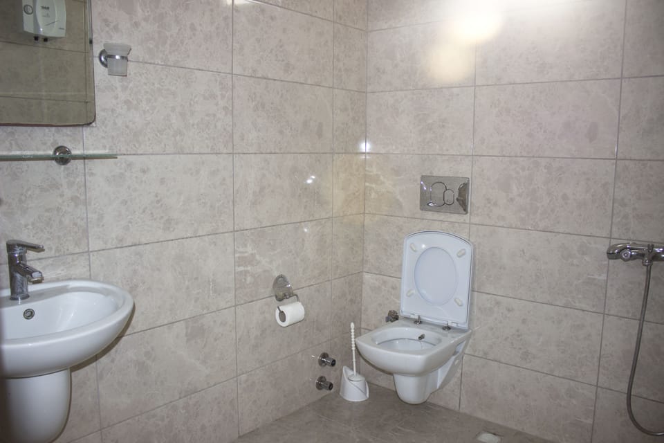 Shower, hair dryer, slippers, towels