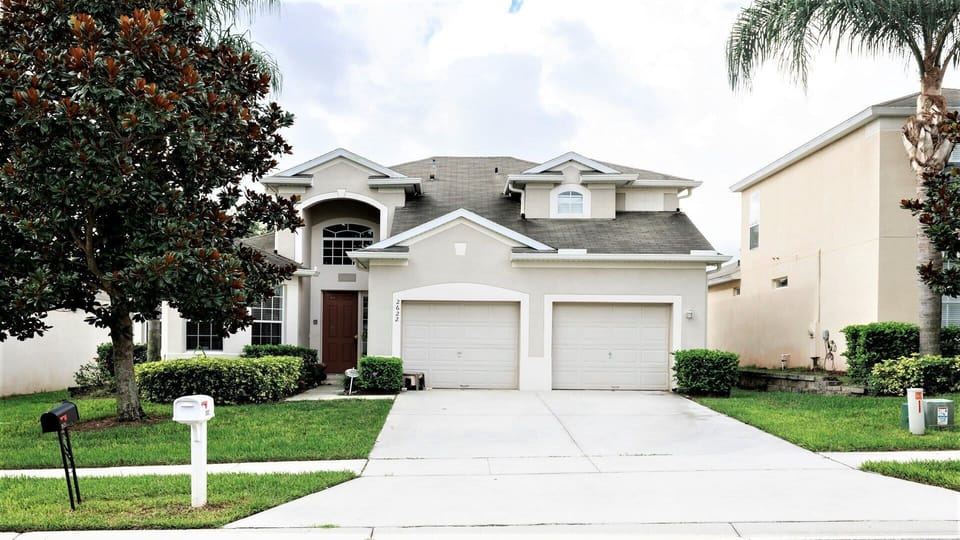 Spacious modern home with lush landscaping, a two-car garage, and great curb appeal.