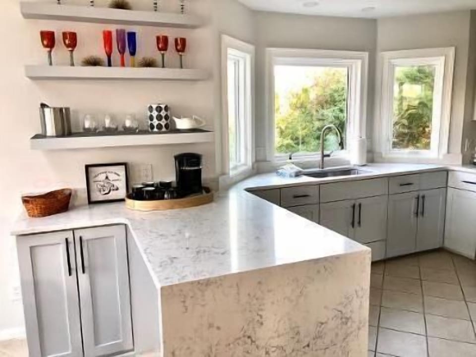 Waterfall marble countertops over new cabinets