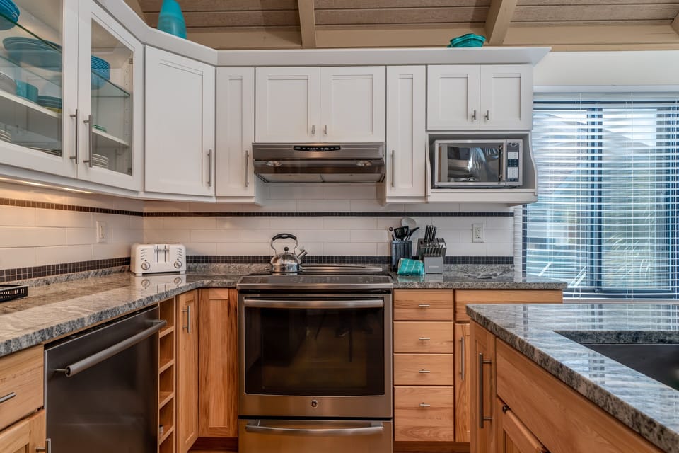 It has a drop-in stove, top of the line dishwasher, & glass accent cabinets.