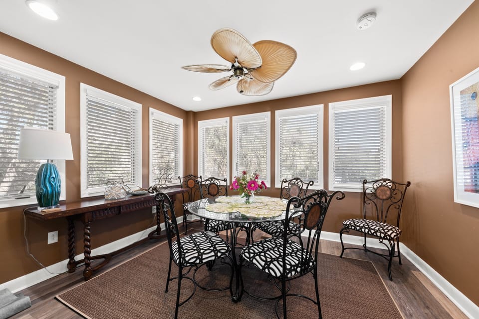 The adjoining dining room makes serving meals easy.  Surrounded by windows, the dining room has a table for 6.