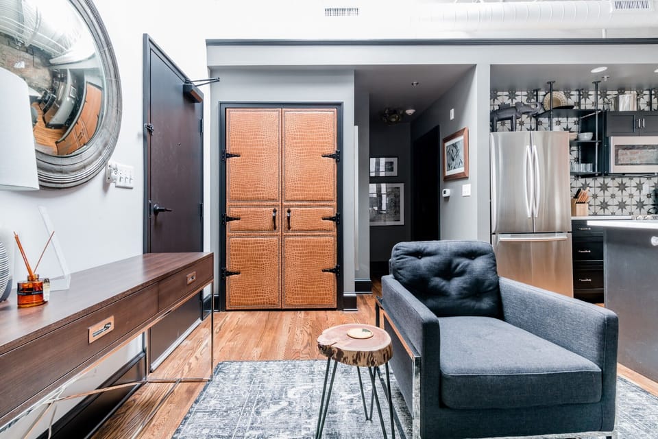 Sink into style in this industrial-chic lounge with curated vintage flair.