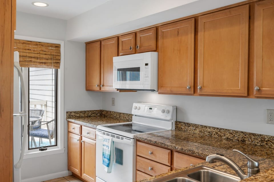 The kitchen has granite counters and is well stocked.
