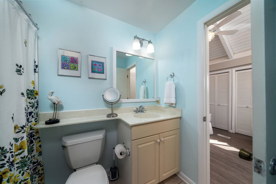 The full bath has access from both the guest bedroom and hall.  There is a tub/shower and large vanity