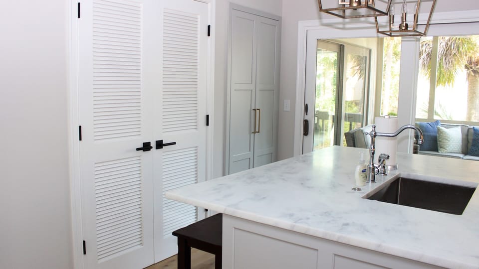 Behind the doors is a pantry. The sliding doors lead to a screened porch.