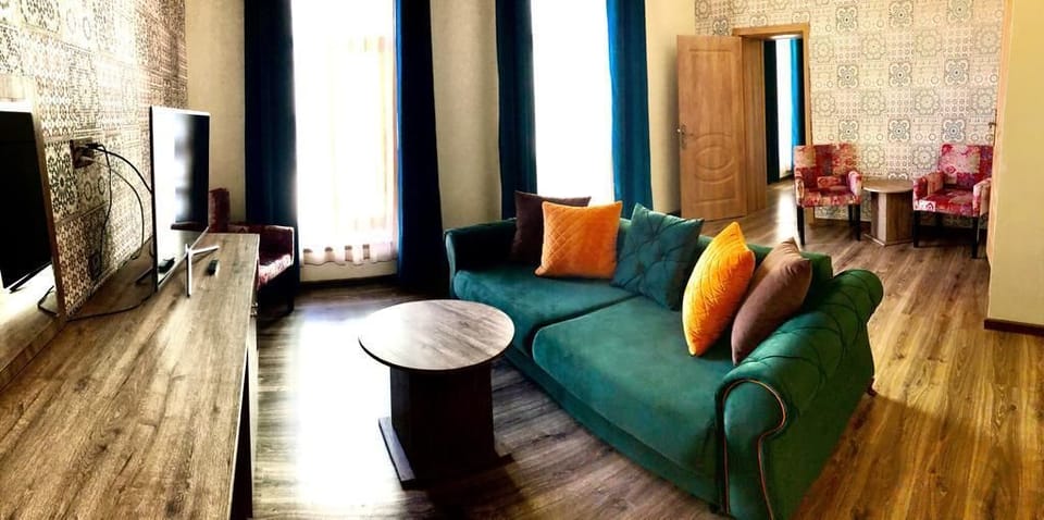 Luxury Suite, 1 Bedroom | Living room | Flat-screen TV