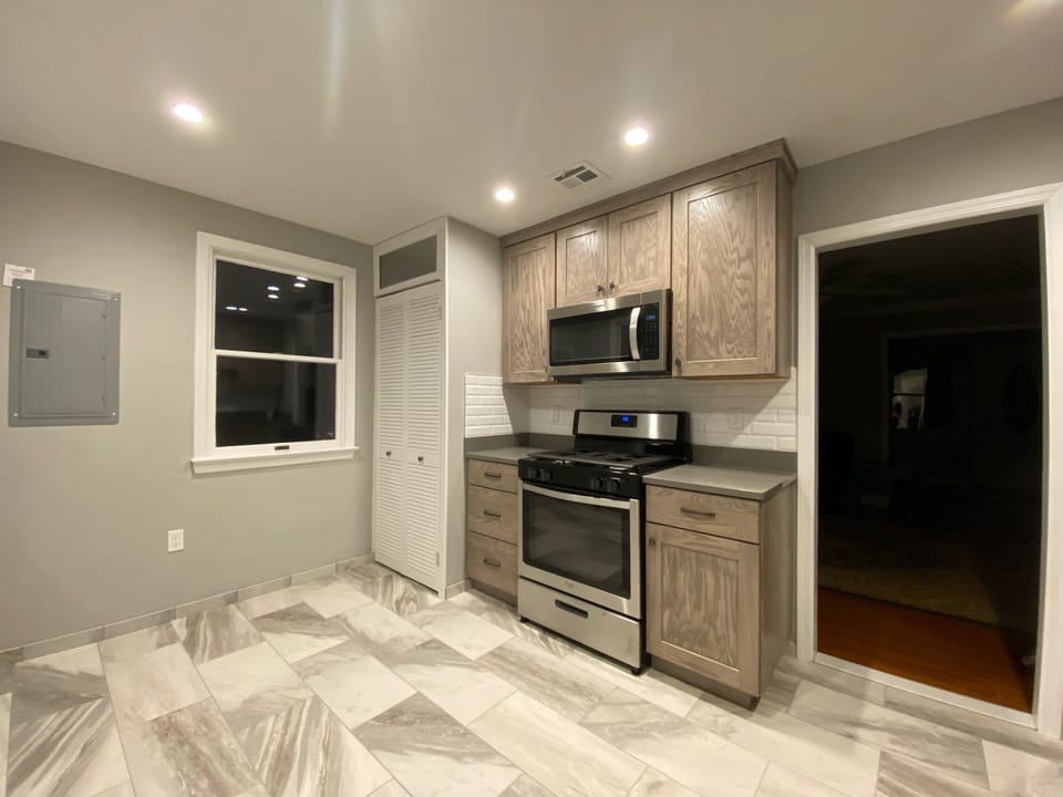 NEW SS appliances, tile backsplash & flooring, custom slow close cabinets
