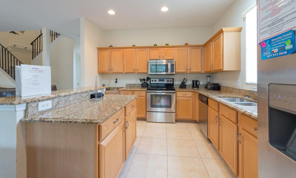 Kitchen; cooker with microwave above.
