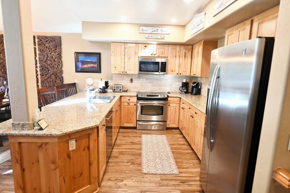 Bright open fully stocked kitchen with plenty of counter and cupboard space!