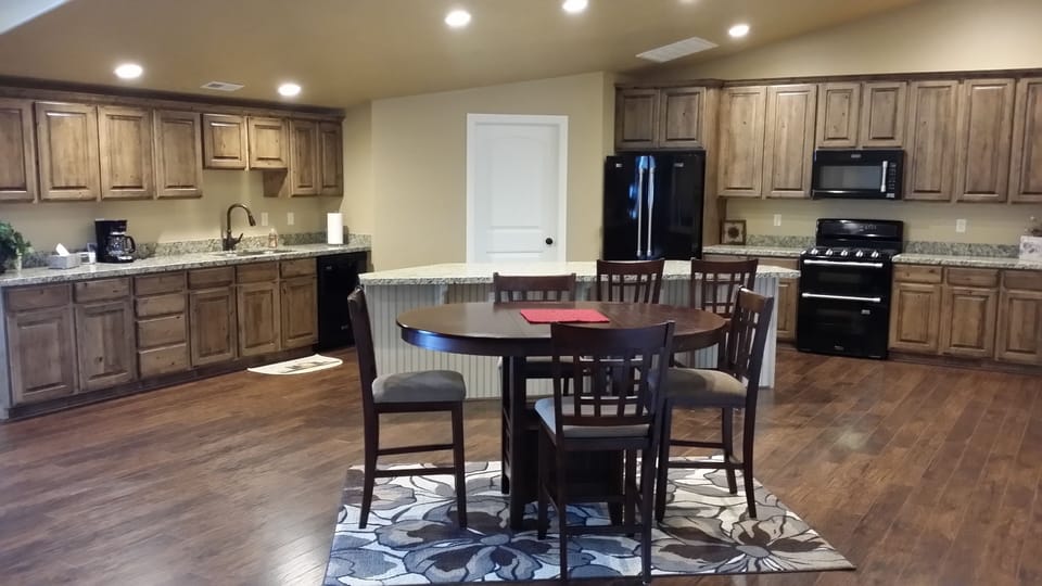 Kitchen with granite counters and new appliances.