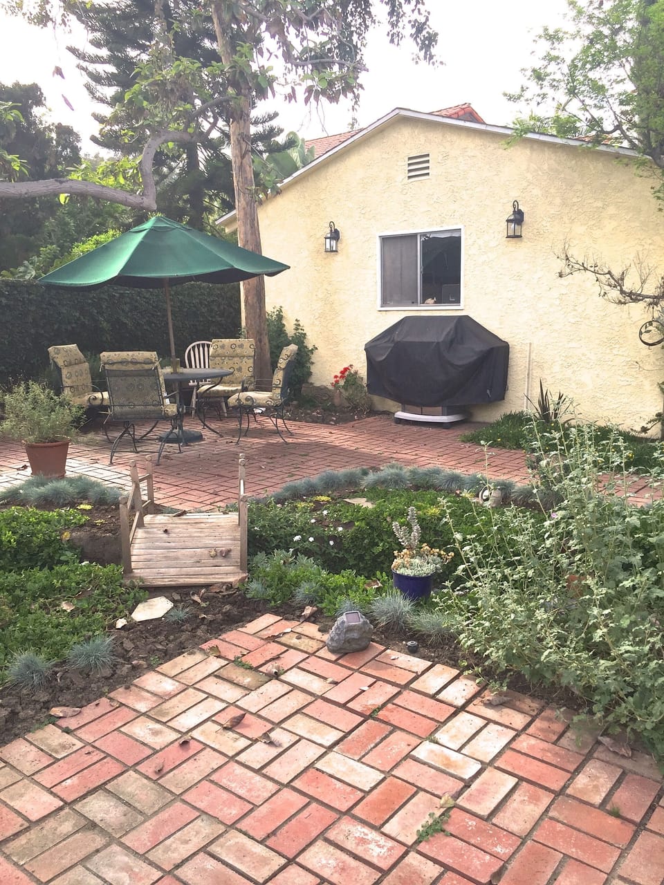 Cozy backyard with patio furniture where you can rest and have a glass of wine.
