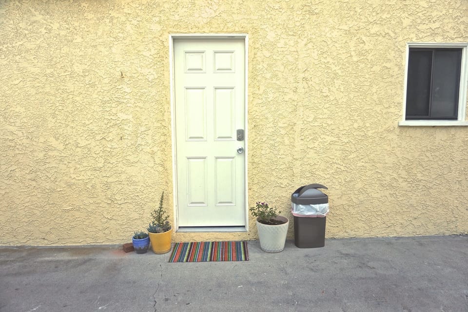 Outside the room, the private entrance door.