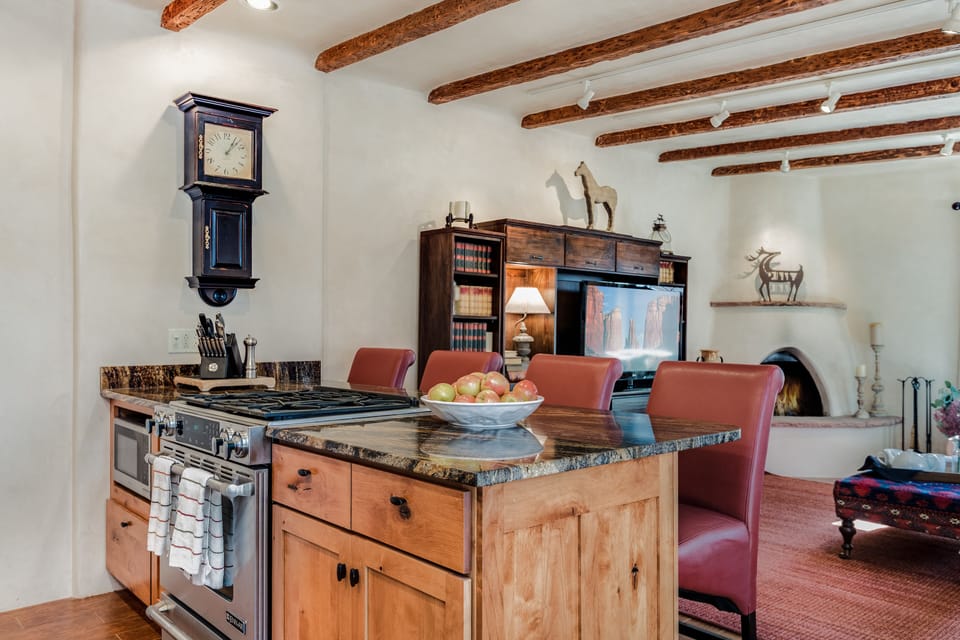 Kitchen with stove, oven, microwave, dishes and utensils. 
