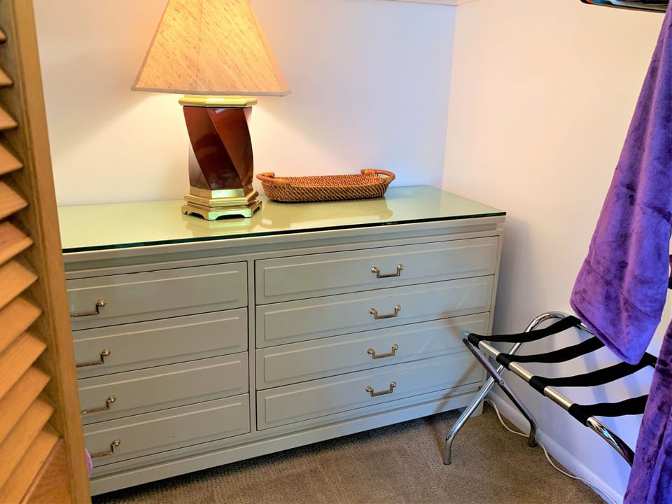 spacious closet with luggage racks and room to tuck things away or hang up. 