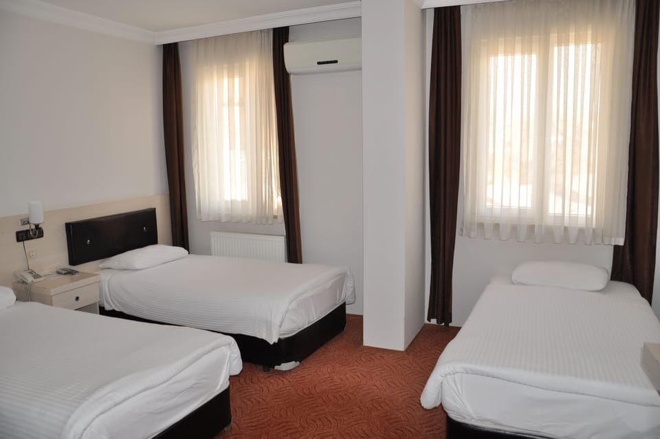 Standard Triple Room | Minibar, in-room safe, desk, blackout drapes