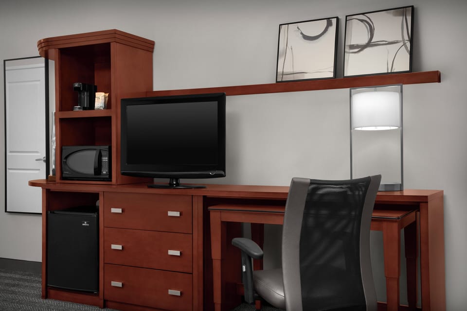 Hypo-allergenic bedding, desk, laptop workspace, blackout drapes
