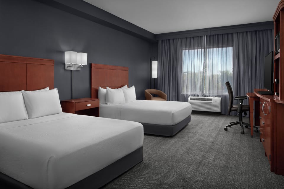 Hypo-allergenic bedding, desk, laptop workspace, blackout drapes
