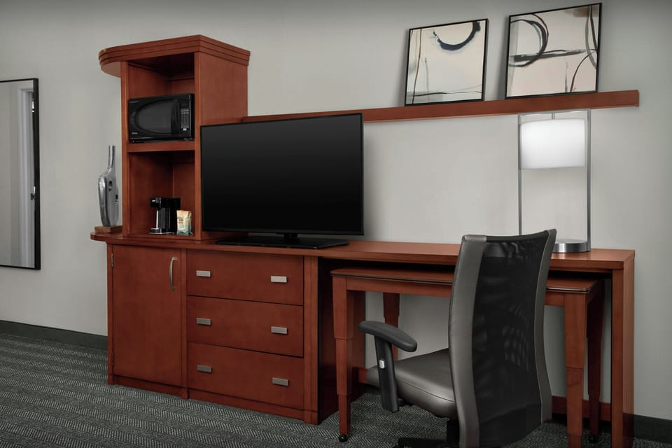 Hypo-allergenic bedding, desk, laptop workspace, blackout drapes