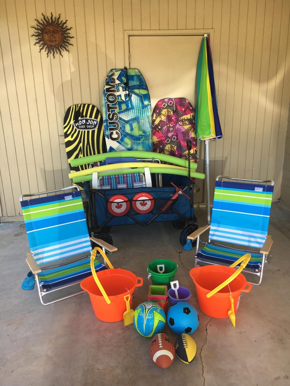 Beach chairs, umbrella, boogie boards, sand toys, balls, & beach wagon