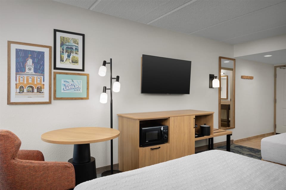 Premium bedding, desk, laptop workspace, blackout drapes