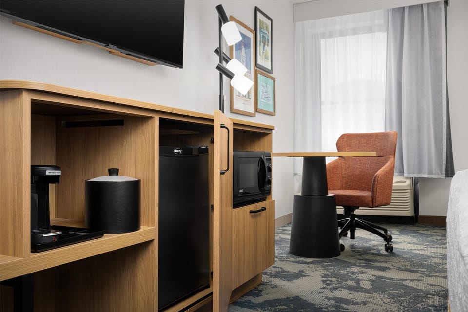 Premium bedding, desk, laptop workspace, blackout drapes