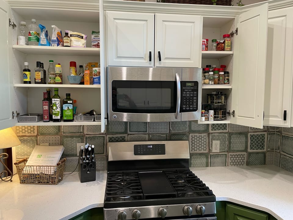 Kitchen is stocked with spices and basic cooking oils.