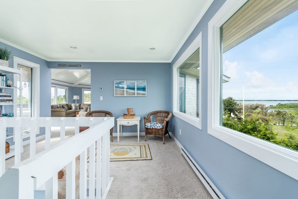 Upstairs seating area surrounded by windows 