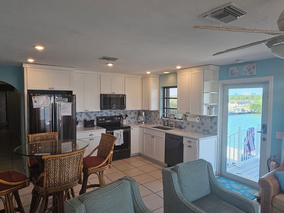 Updated, furnished kitchen with stainless, quartz and backsplash.  Open concept.