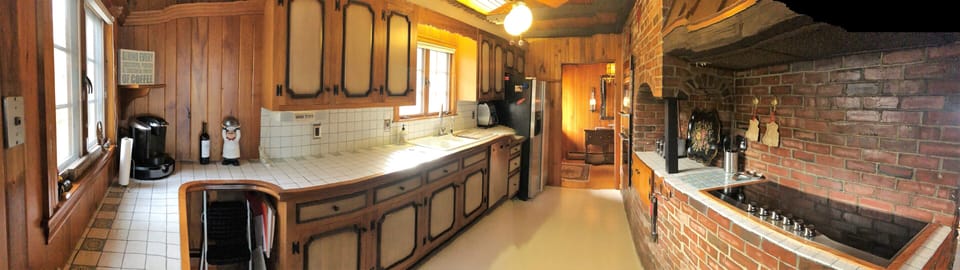 Galley kitchen with modern top of the line appliances- next to the dining room