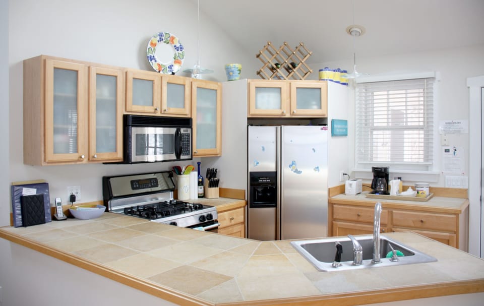 Fully equipped kitchen with island, stainless appliances, cooking gear