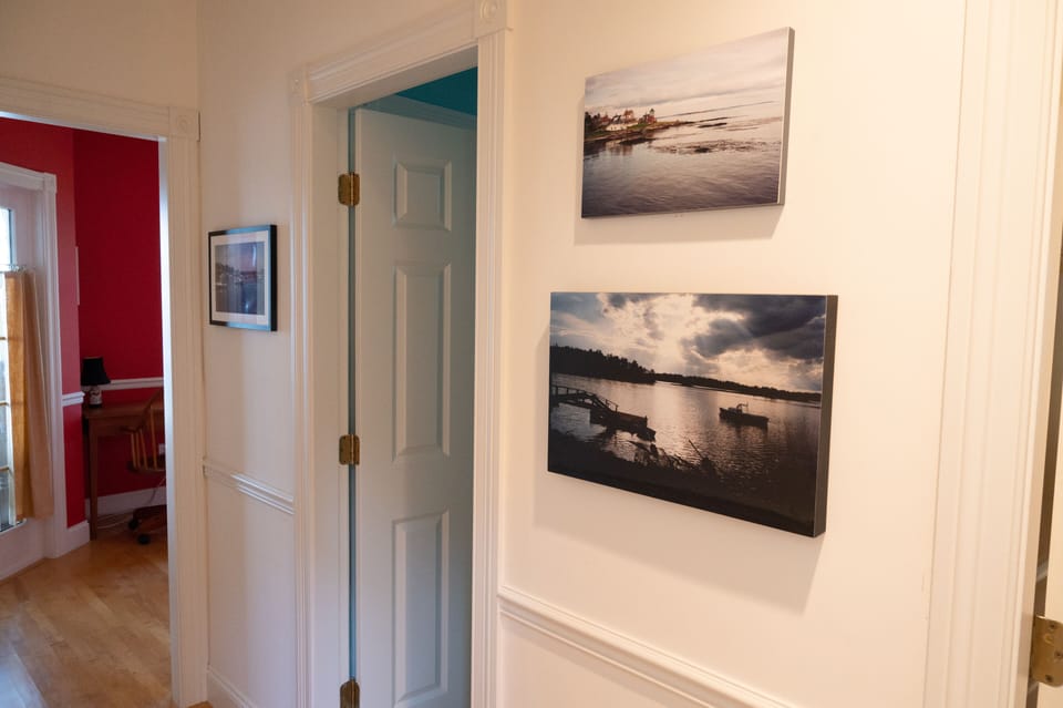 Hallway to downstairs bath and den
