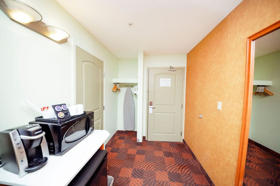 Premium bedding, desk, laptop workspace, blackout drapes