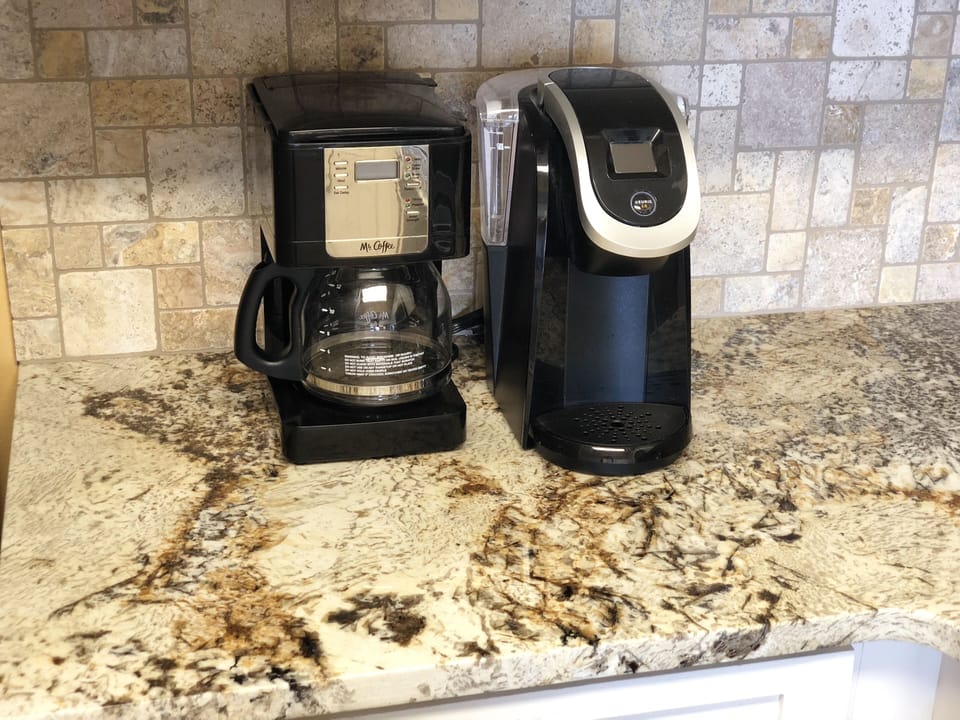 Very nice granite, travertine backsplash,  Keurig and coffee maker