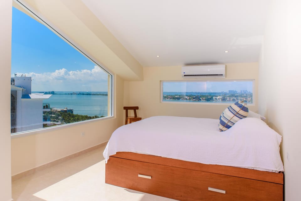  Upstairs bedroom features massive windows, a king size bed, a pull out queen.