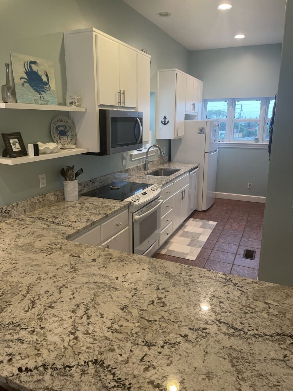 Kitchen main floor with new granite countertops and stainless steel sink.