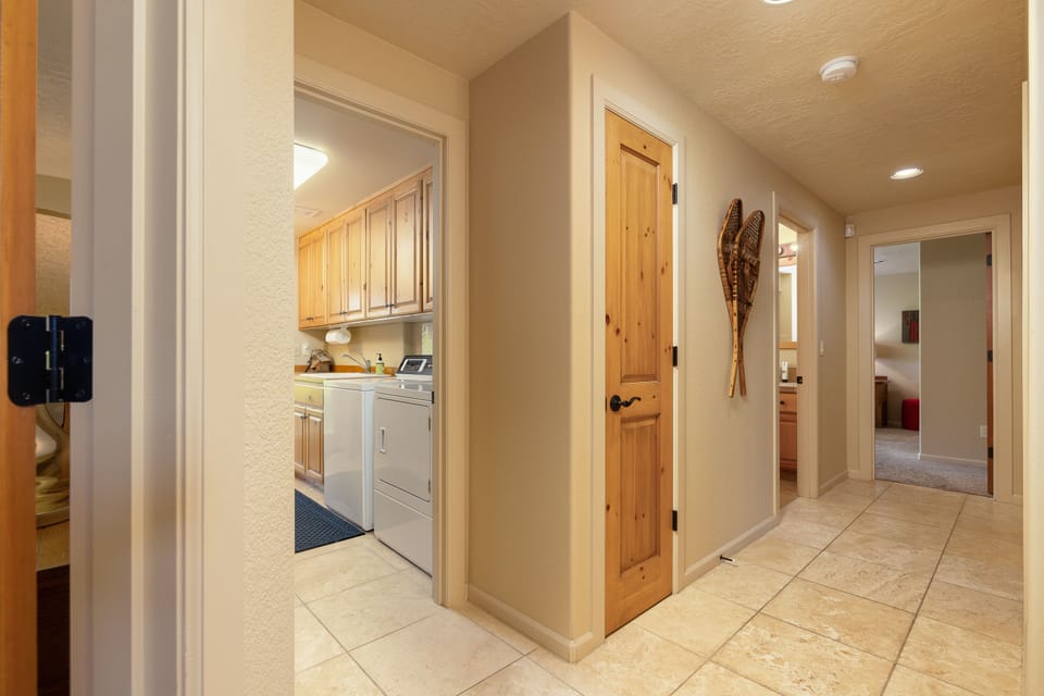 Downstairs hallway, laundry room, 2 master ensuite bedrooms, bunk room-full bath