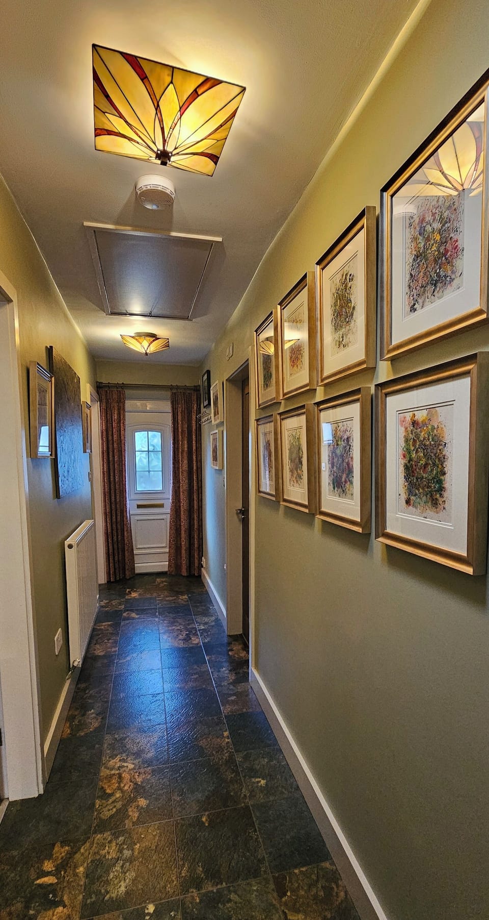 Hall leading to bedrooms and bathroom, even more original art