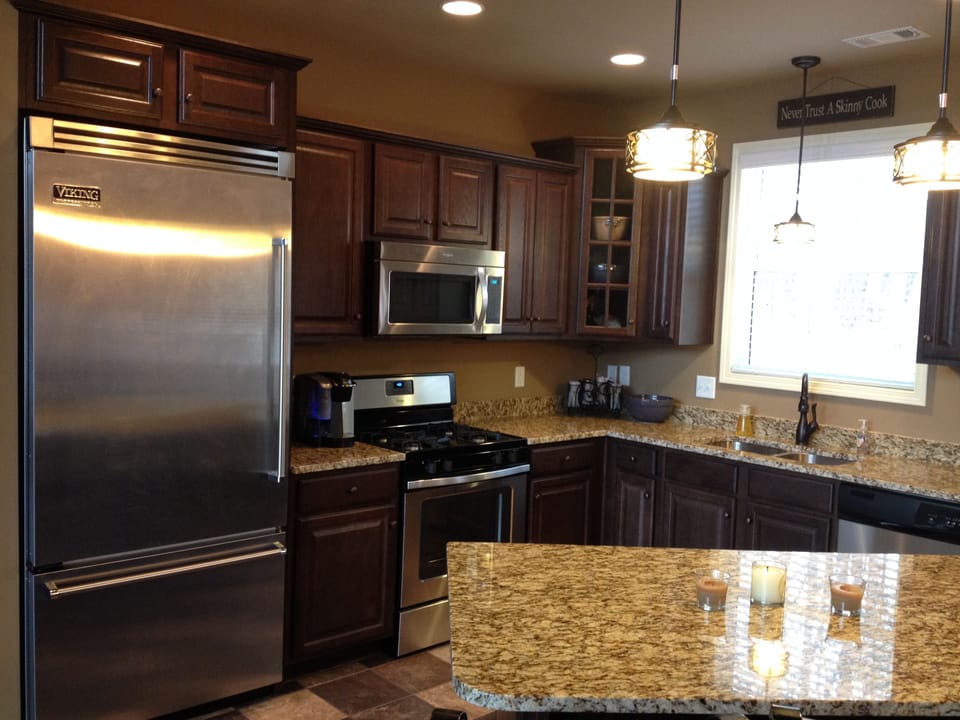 Open floor plan kitchen with island.  Viking fridge, gas stove and elec oven