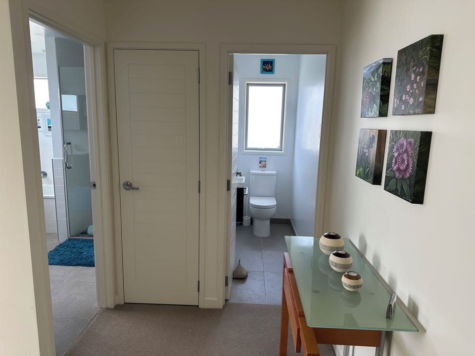 Toilet next to bathroom