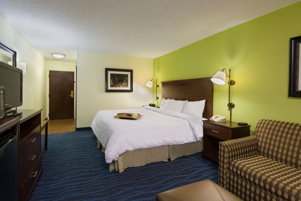 Premium bedding, desk, laptop workspace, blackout drapes