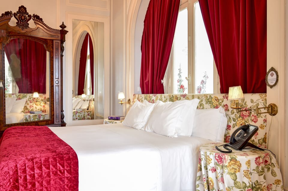 Deluxe Suite, River View | Minibar, in-room safe, desk, iron/ironing board